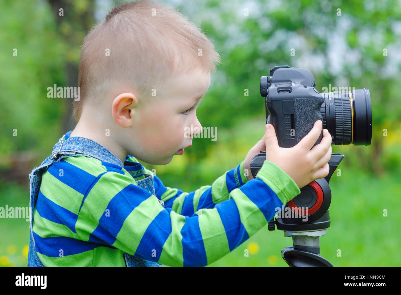 little boy takes off on a photo camera Stock Photo
