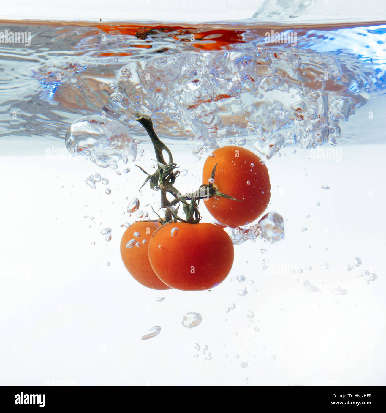 Fresh cherry tomatoes with water splash isolated on white backgr Stock ...
