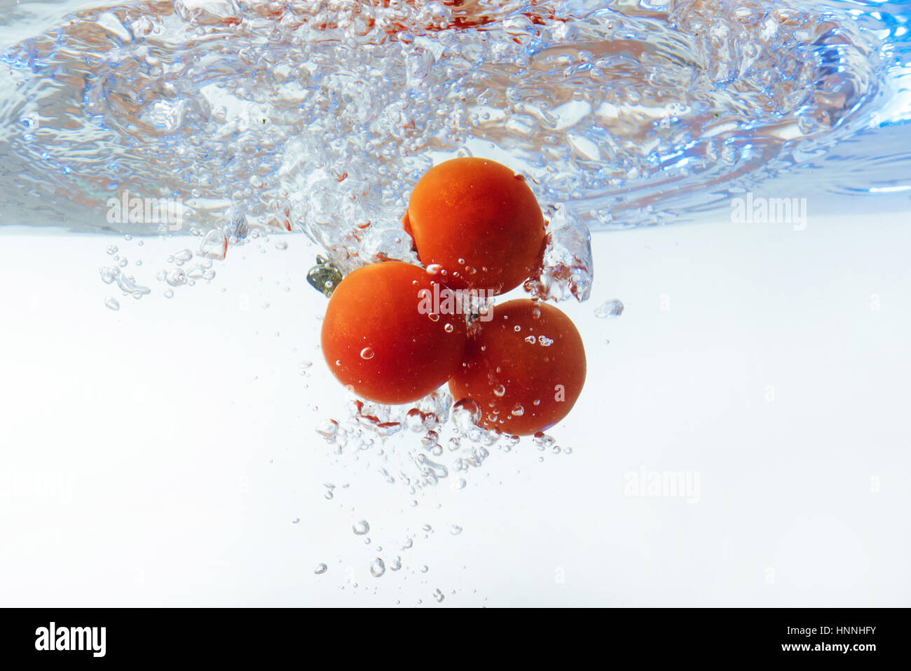 Fresh cherry tomatoes with water splash isolated on white backgr Stock ...