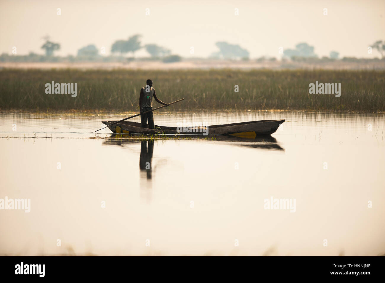 Namibian fisherman and traditional dug-out canoe Stock Photo