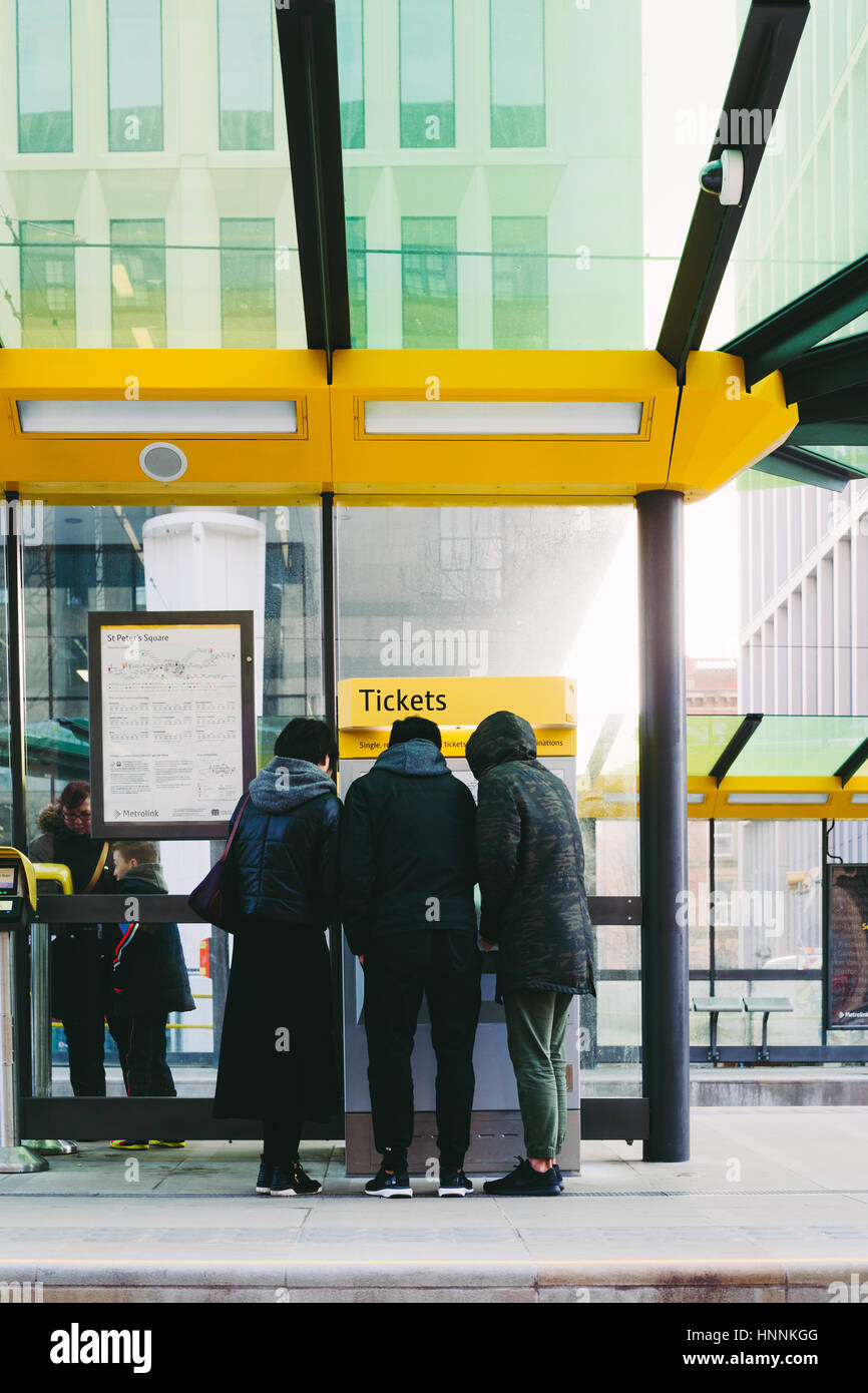People at a ticket machine. Metrolink station, Manchester. Stock Photo