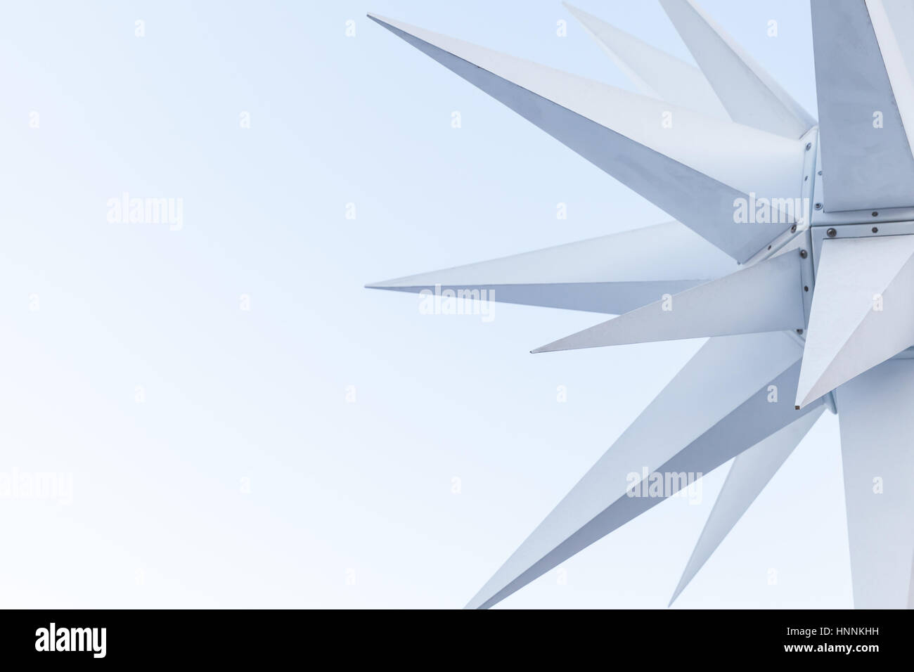 Fragment of modern white outdoor decoration in shape of three dimensional star over blue sky background Stock Photo