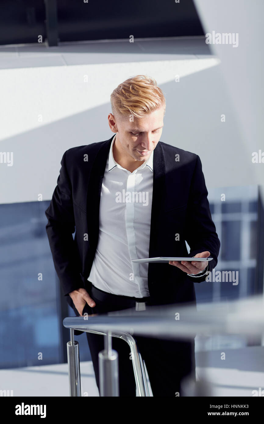A man in a suit with tablet in his hand the office Stock Photo
