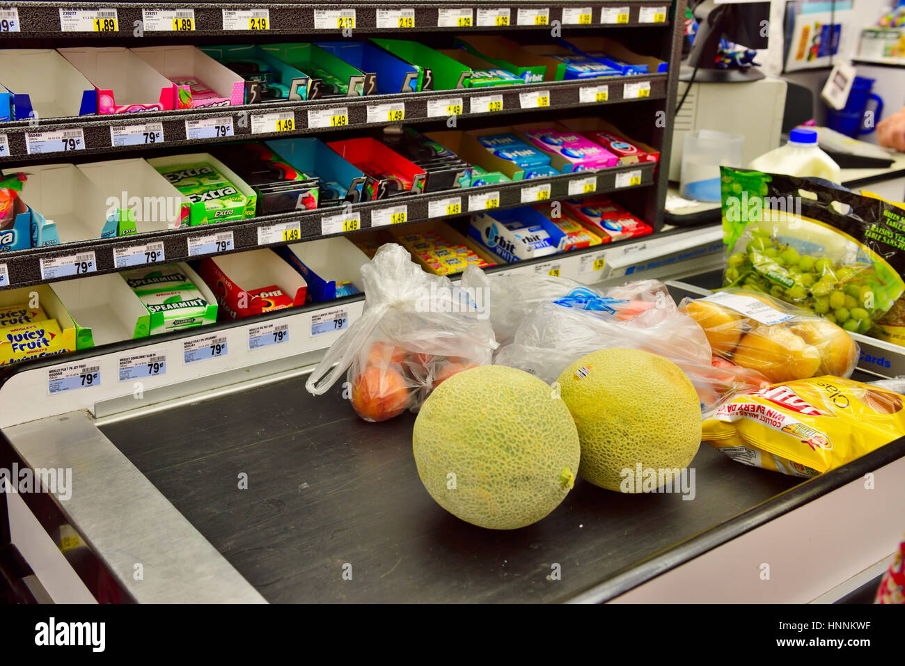 Produce on supermarket check out conveyor belt with impulse purchase check-out display Stock Photo