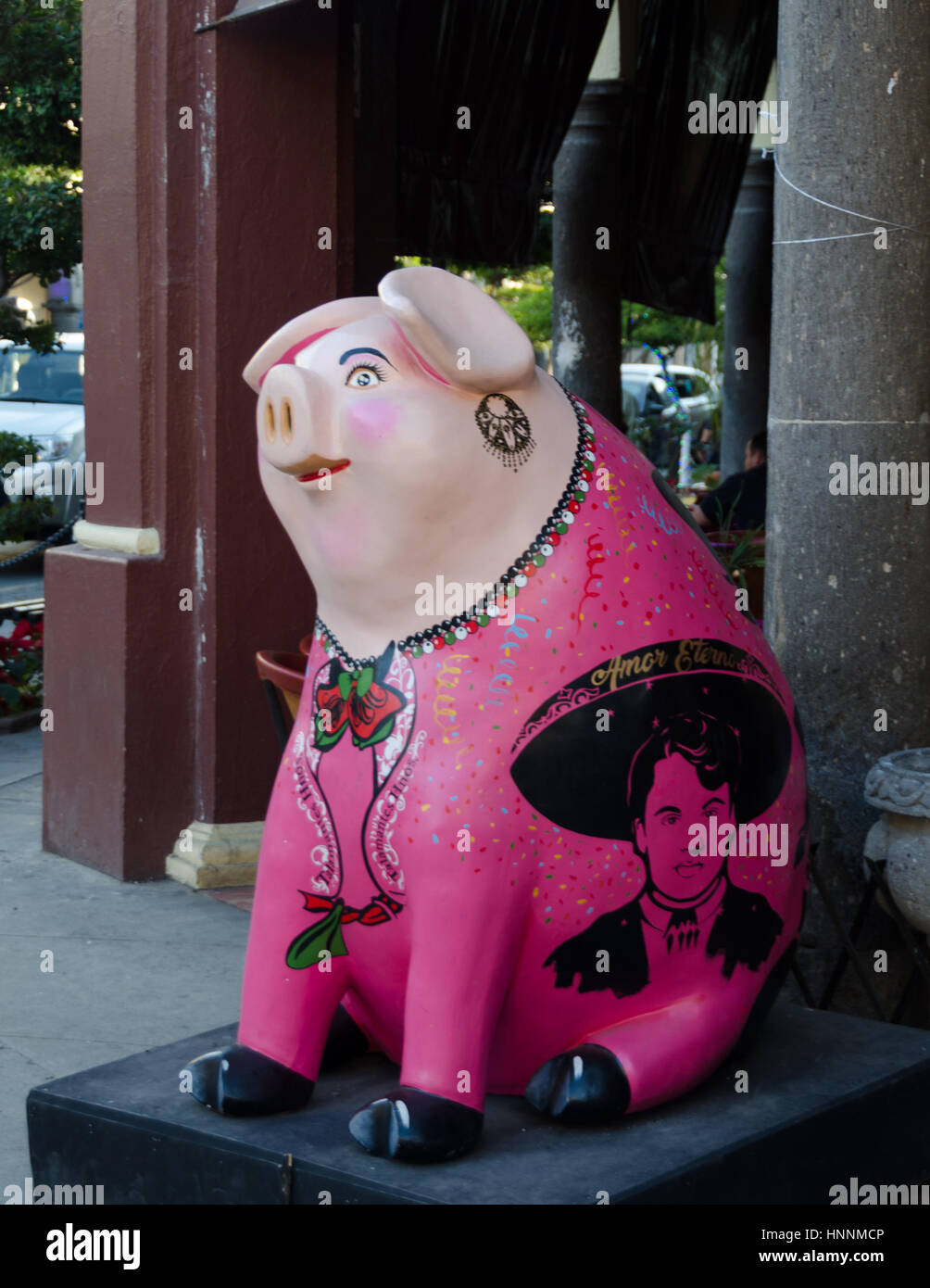 Numerous businesses in Tlaquepaque are promoting local arts by sponsoring a pig statue. Stock Photo