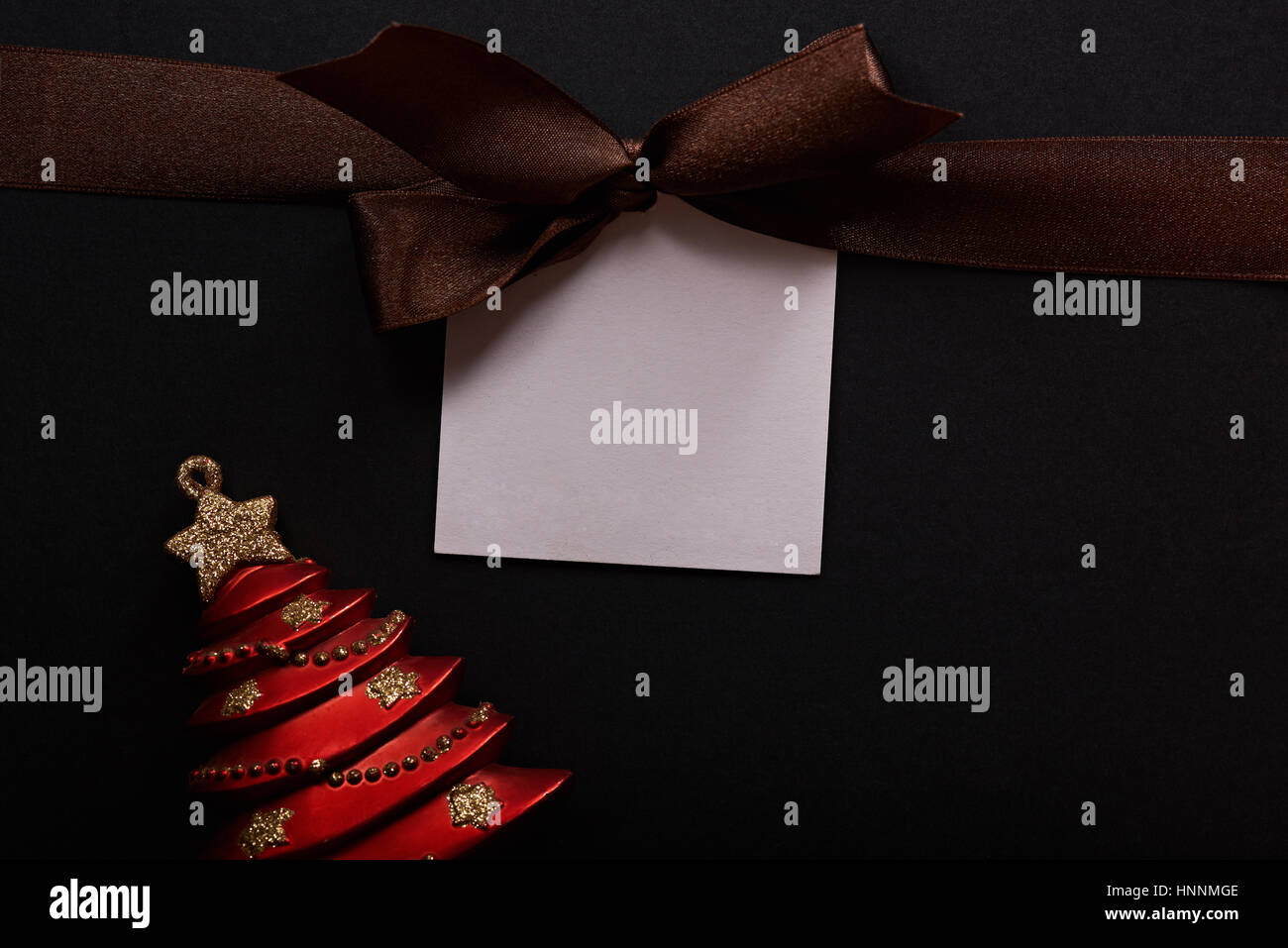 Brown ribbon with message empty tag on christmas celebration close up Stock Photo