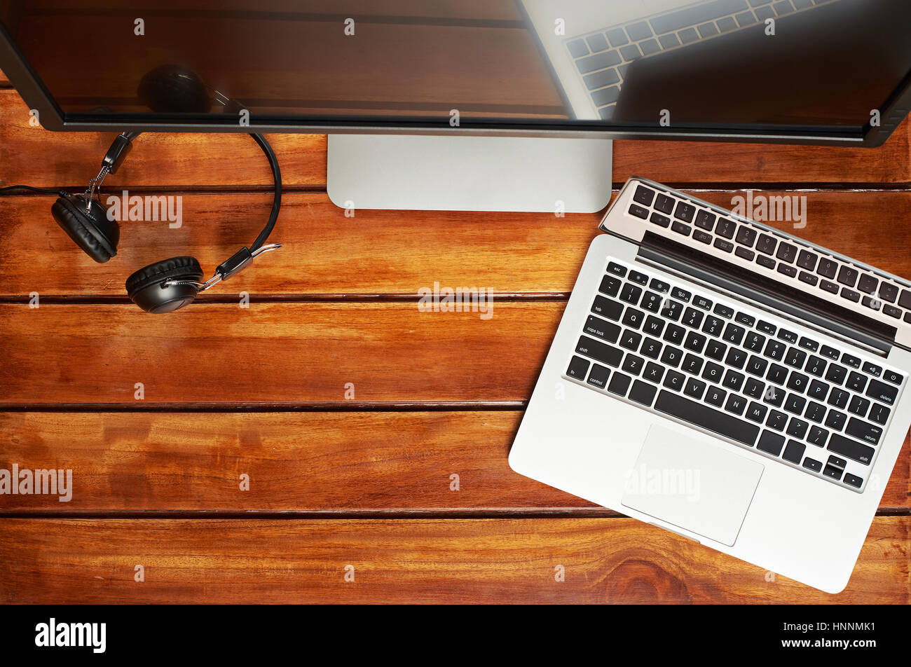 Computer wooden desk view from top. Modern laptop with big screen for