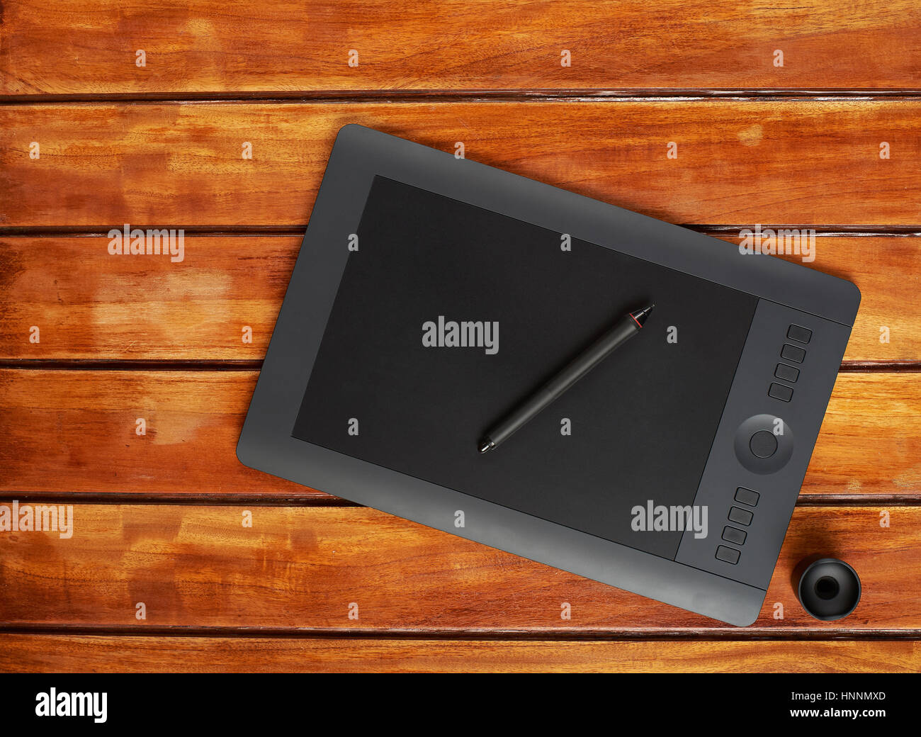 Graphic design tablet on wooden brown table view above Stock Photo