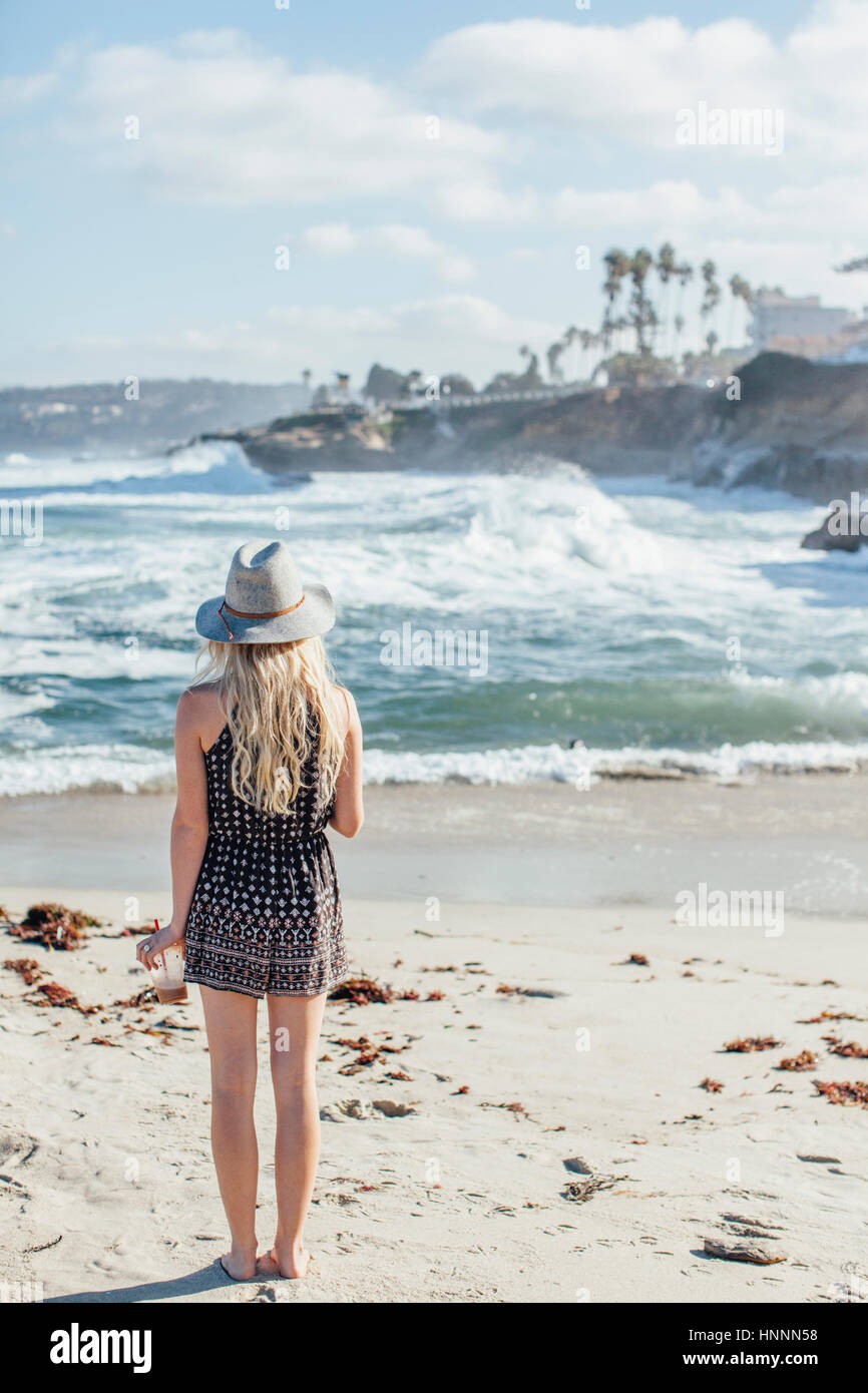 Young woman standing sand beach hi-res stock photography and images - Alamy