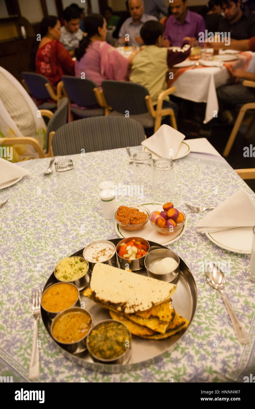 Family eating and Vegetarian thali plate meal on table in restaurant in