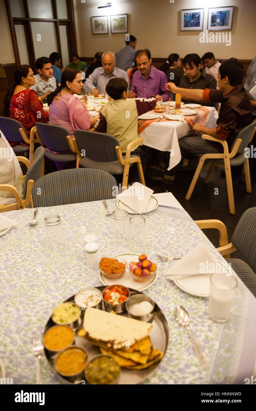 Family eating and Vegetarian thali plate meal on table in restaurant in