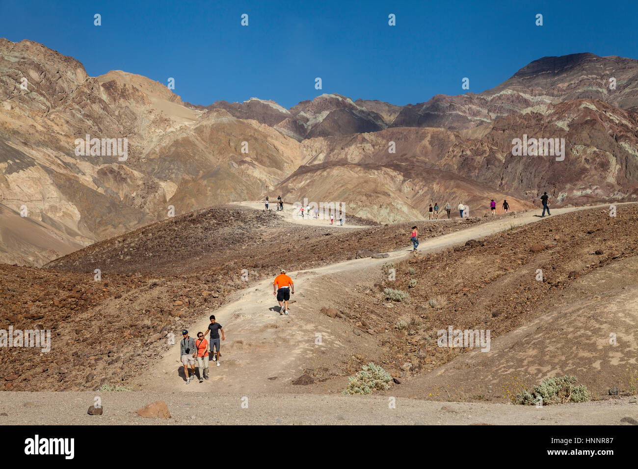 Tourists hiking on a trail in the Death Valley National Park ...