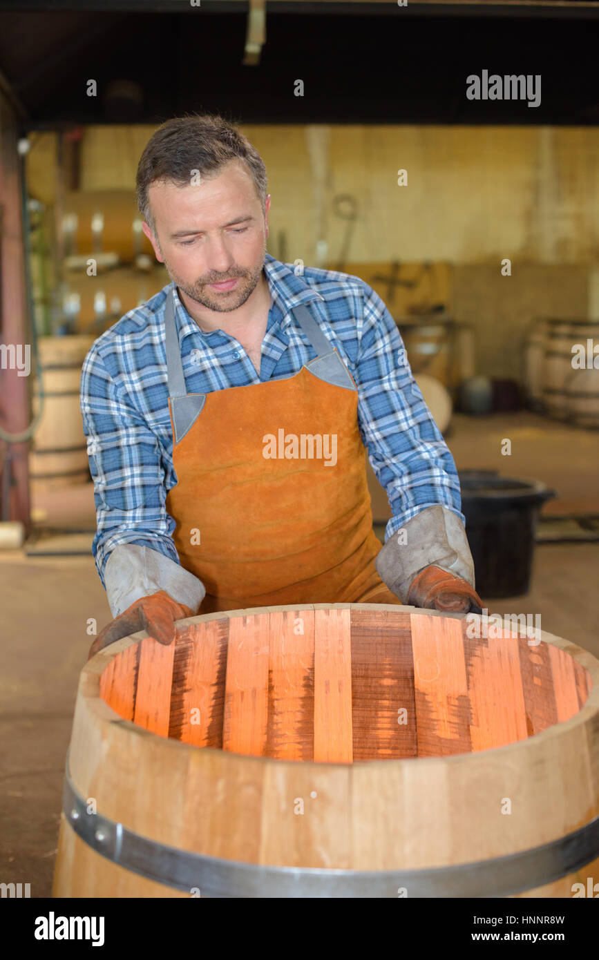 wood barrels production cooper using hammer and tools in workshop Stock ...