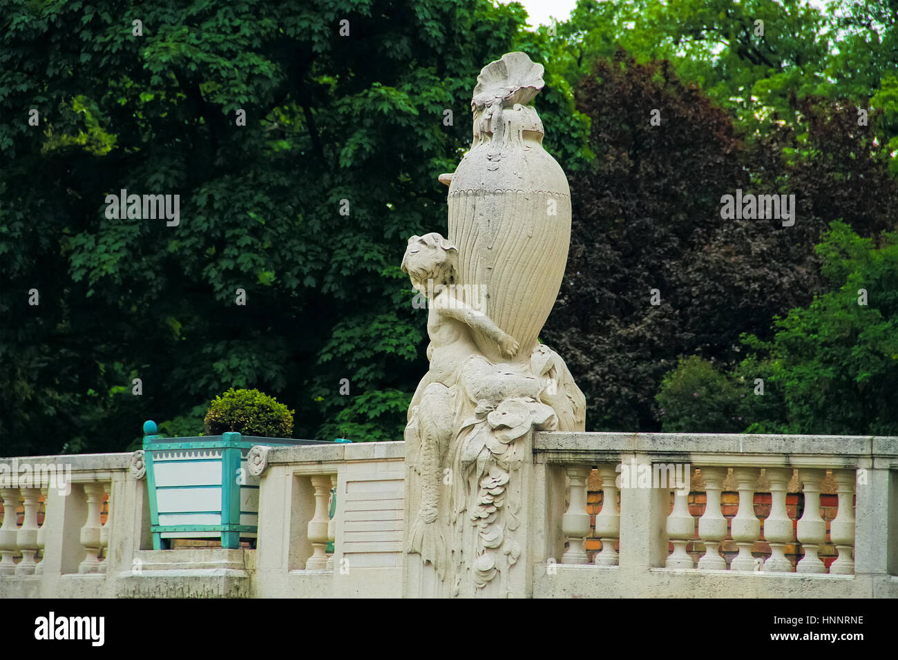 The statue of a boy with a big vase on the bridge Stock Photo