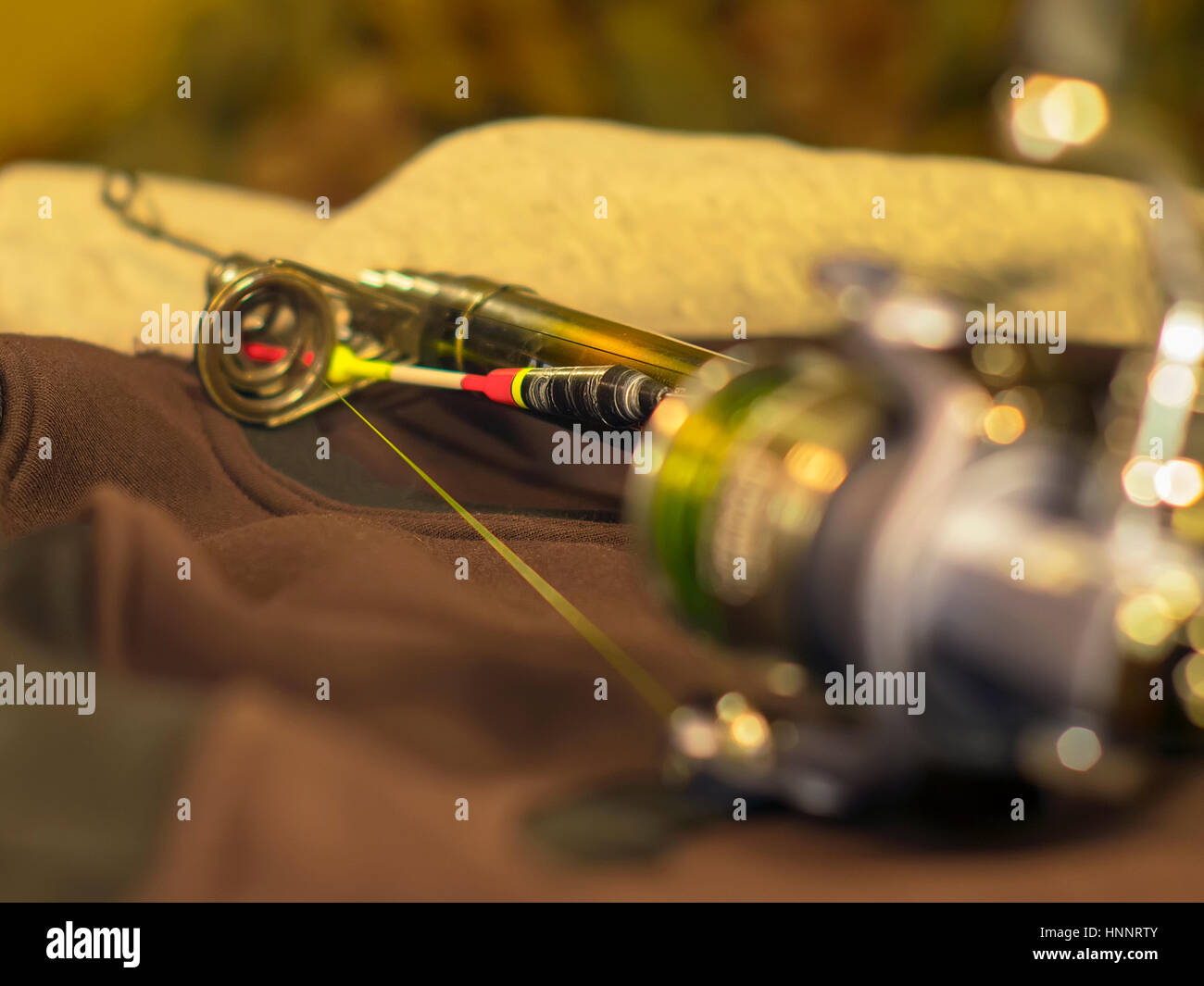 The bright float, fishing rod and fishing reel Stock Photo Alamy