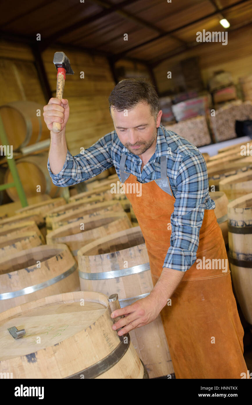 wood barrels production cooper using hammer and tools in workshop Stock ...