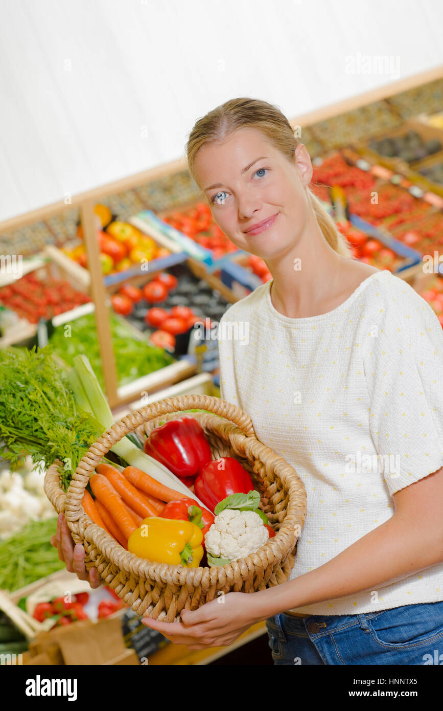 Woman holding up her shopping basket Stock Photo - Alamy