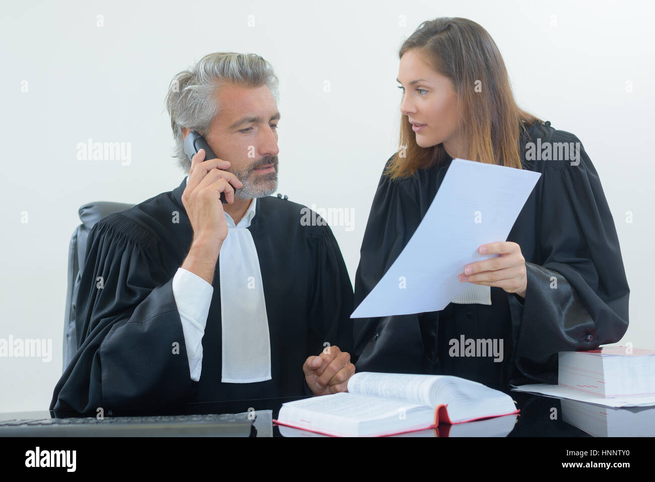 Judge Questioning judges in discussion Stock Photo - Alamy