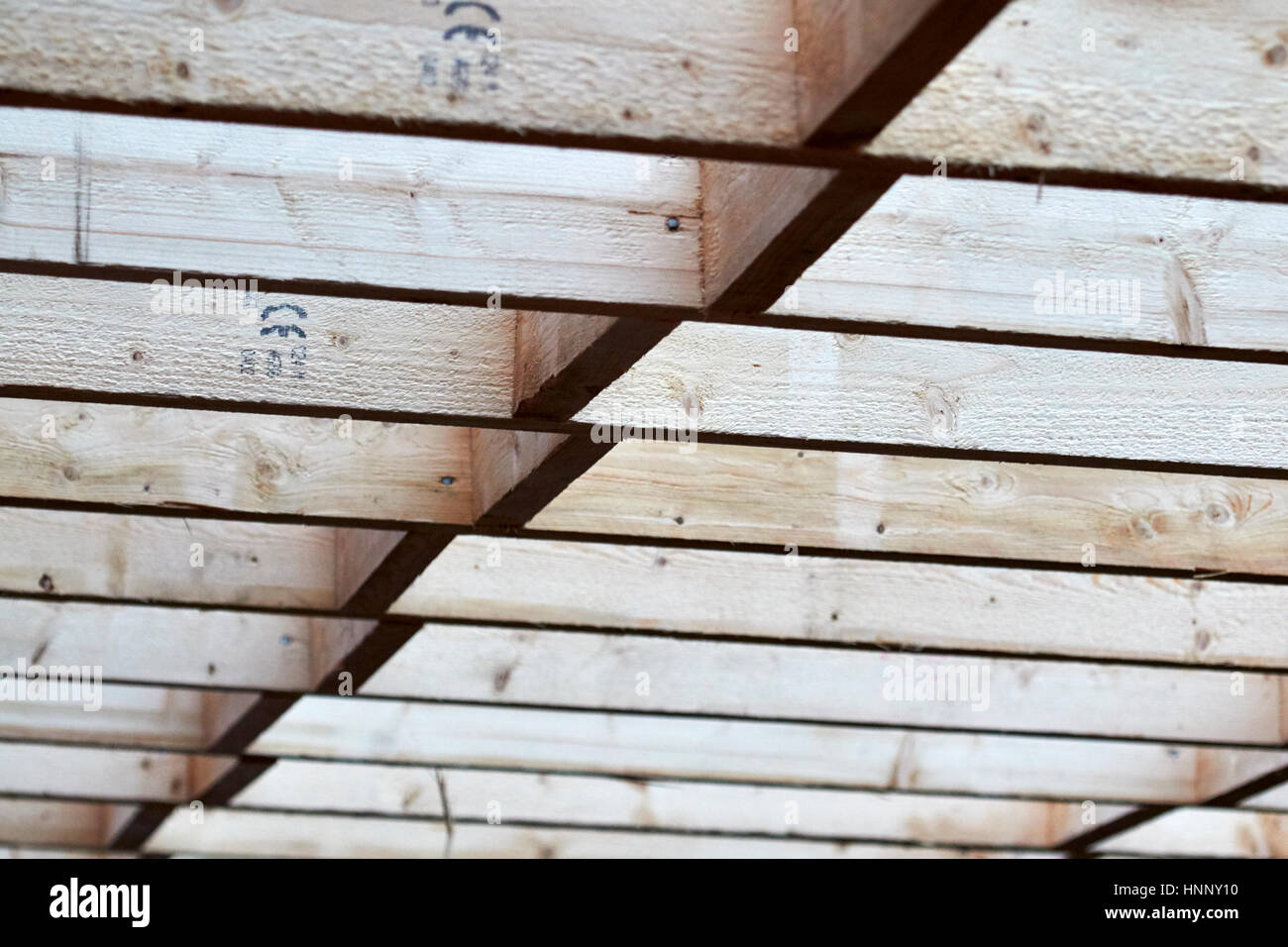 row of wooden roof rafter timbers in extension construction in the uk Stock Photo