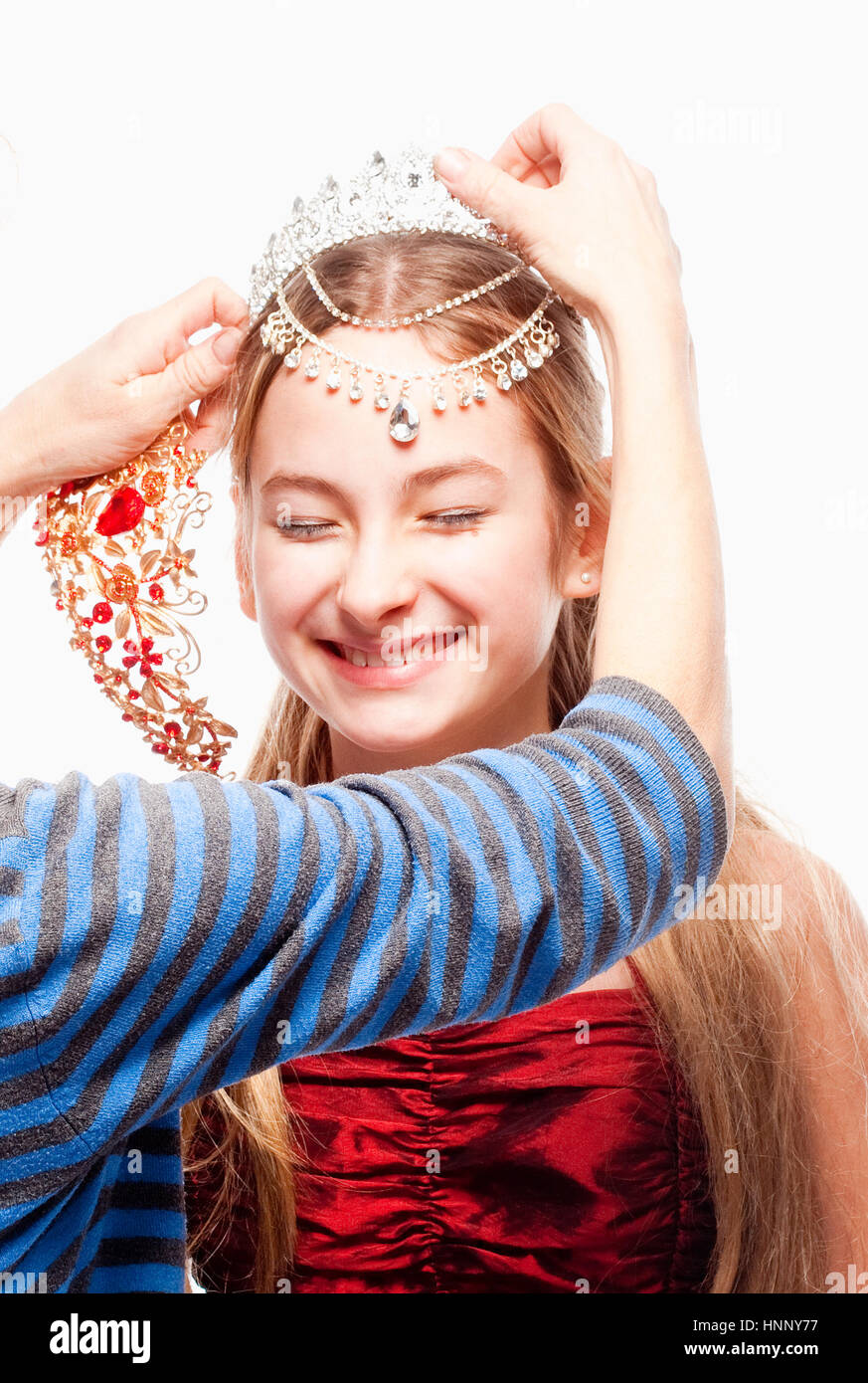 Girl with Blond Hair in Red Dress Fitting a Crown on her Head Stock ...