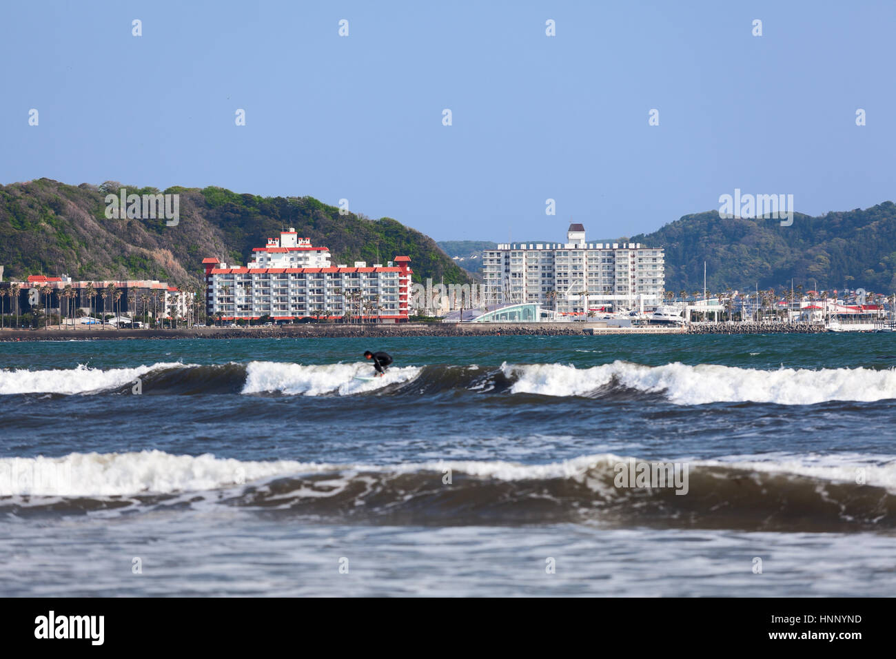 The Yuigahama beach with hotel buildings. It is a good place for surfing on coast of Pacific ocean in the Sagami Bay. Kamakura town, Japan Stock Photo