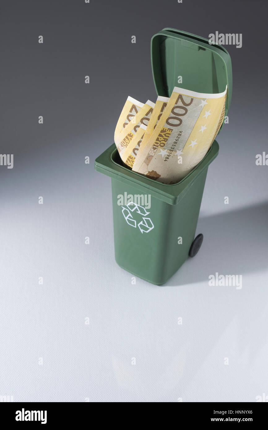 Image of bills / banknotes in a toy recycling bin wheely bin / wheelie