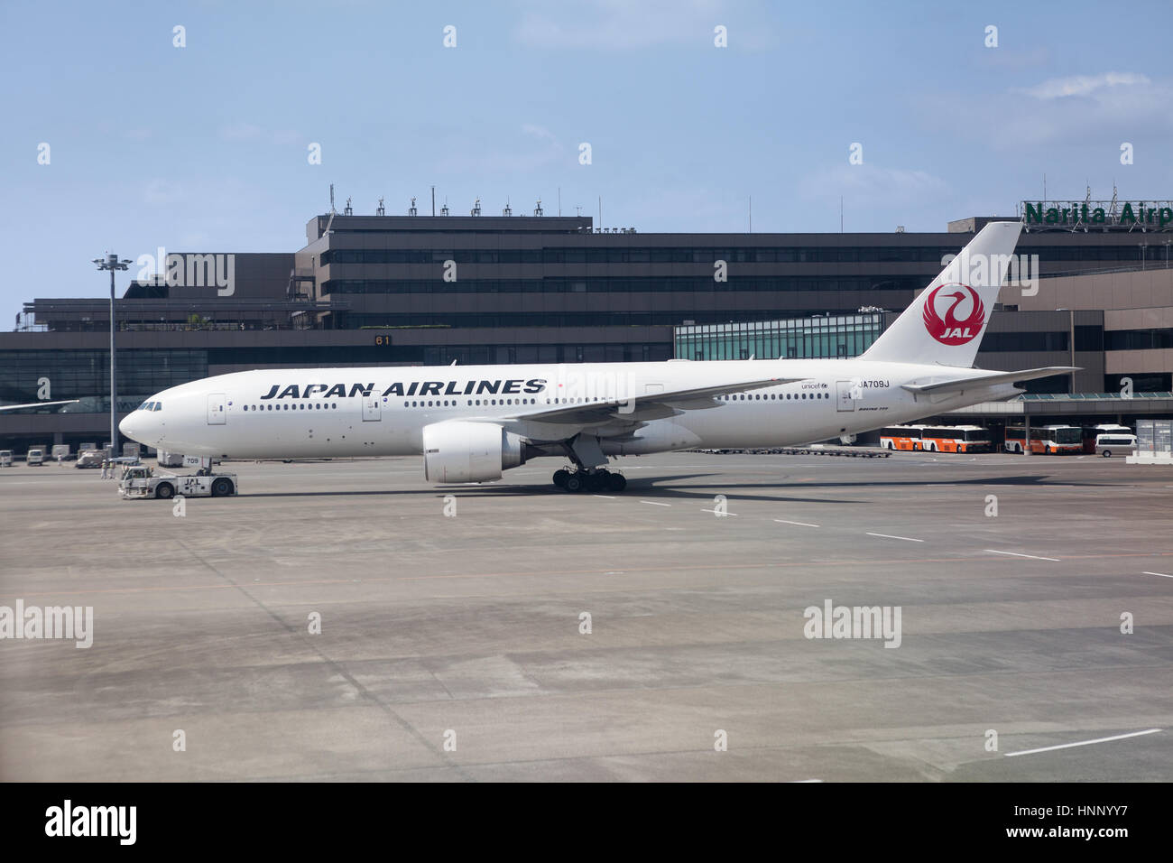 NARITA, JAPAN - CIRCA APR, 2013: Boeing 777 of JAL airline is under towing on runway in the Narita International Airport. Japan Airlines (JAL) is the  Stock Photo
