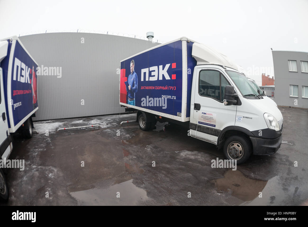 ST. PETERSBURG, RUSSIA - CIRCA JAN, 2016: Small lorries parking lot with empty place. Wide angle view. Russian transportation company PEC (First exped Stock Photo