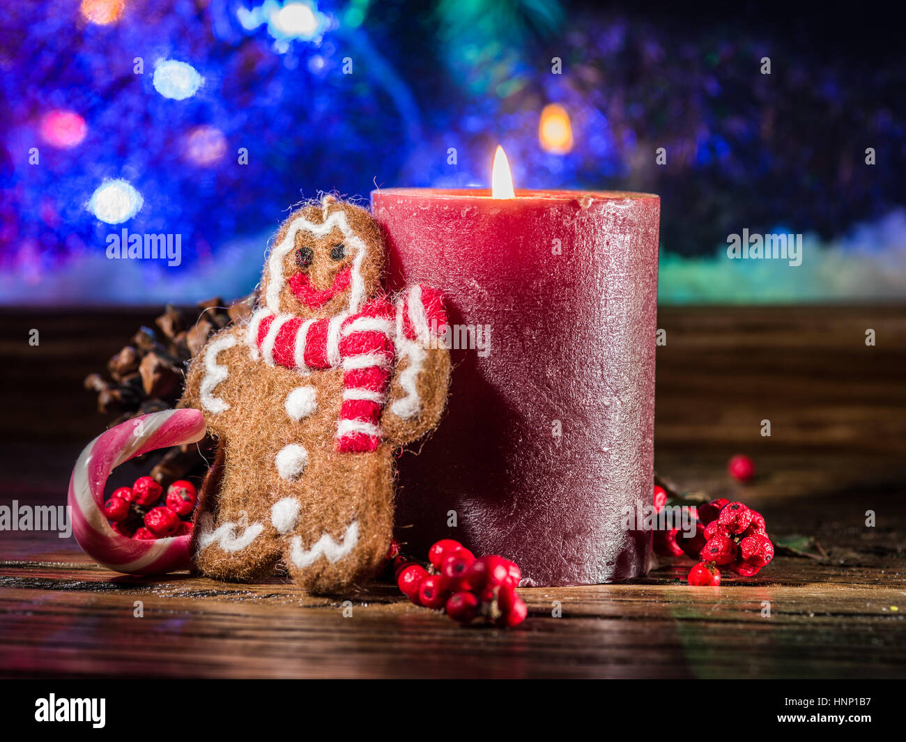 Gift boxes, candle lights and frozen window. Christmas background. Stock Photo