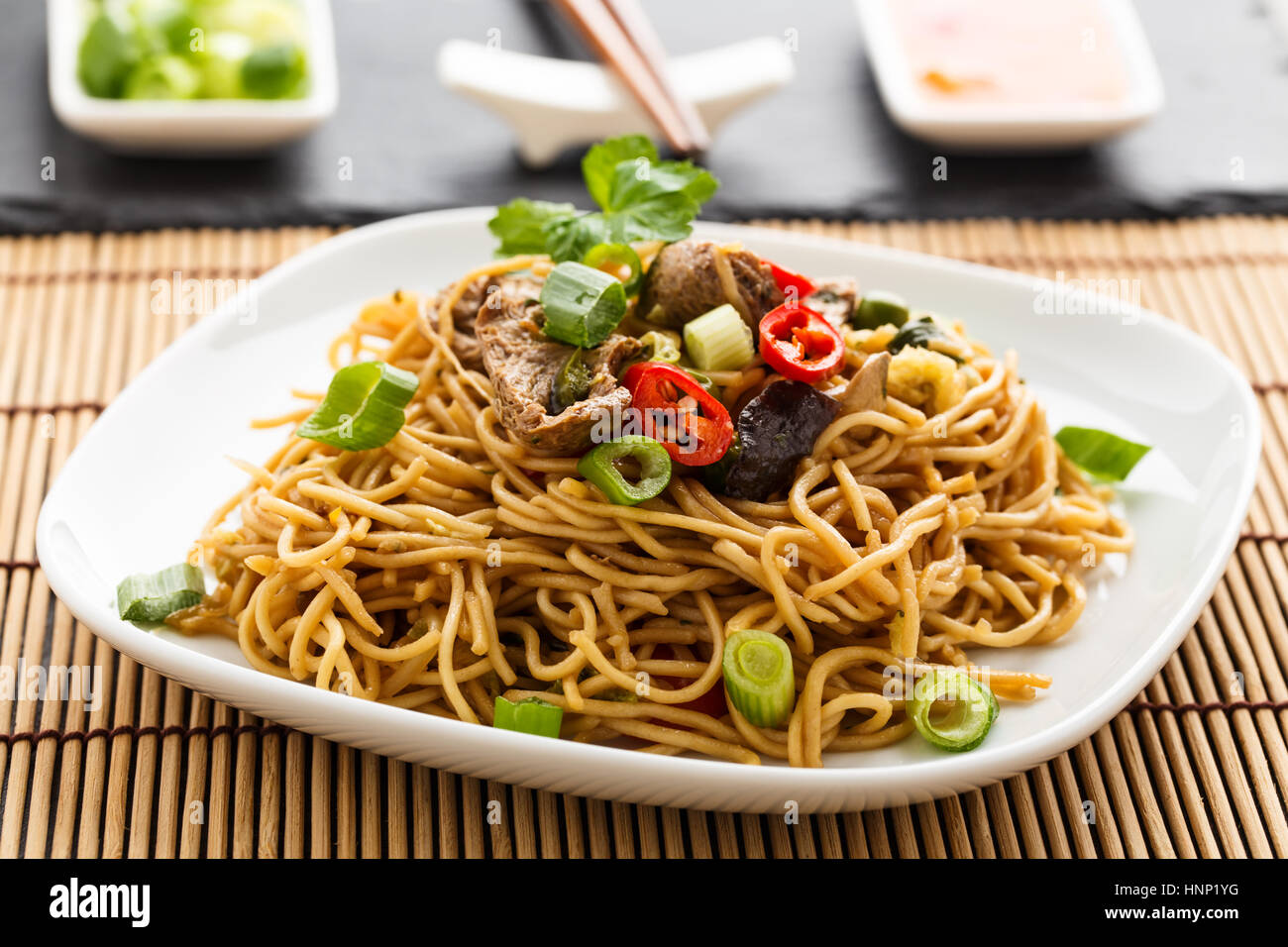 Lo mein with vegetables, mushrooms and soy filets. Stock Photo