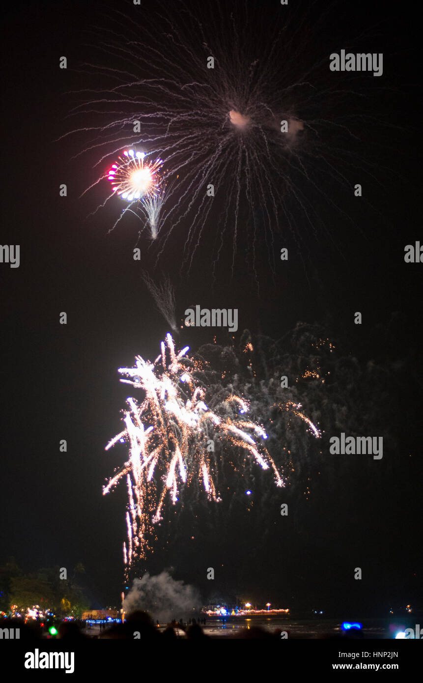 Bright firework explosions on the night sky. Stock Photo