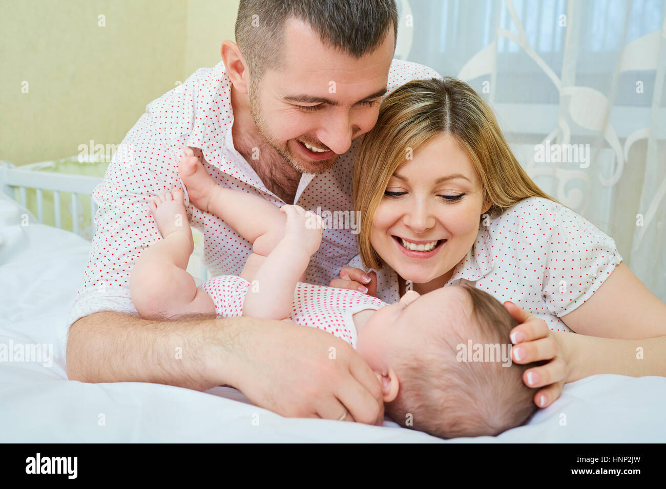 Mother Father And Baby Playing On The Bed The Concept Of A Happ Stock Photo Alamy