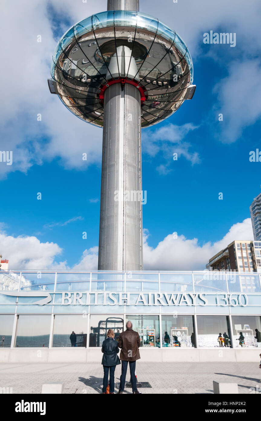Visitors watcjing the British Airways i360 ascend the observation tower on Brighton seafront. Stock Photo