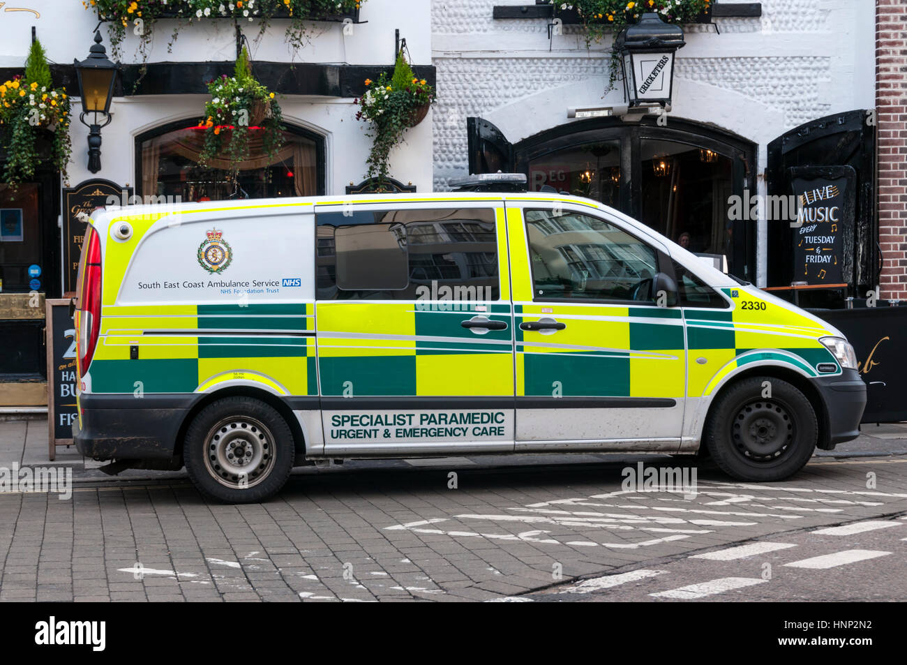Logo and name of South East Coast Ambulance Service NHS Foundation Trust on the side of a paramedic ambulance parked in Brighton. Stock Photo