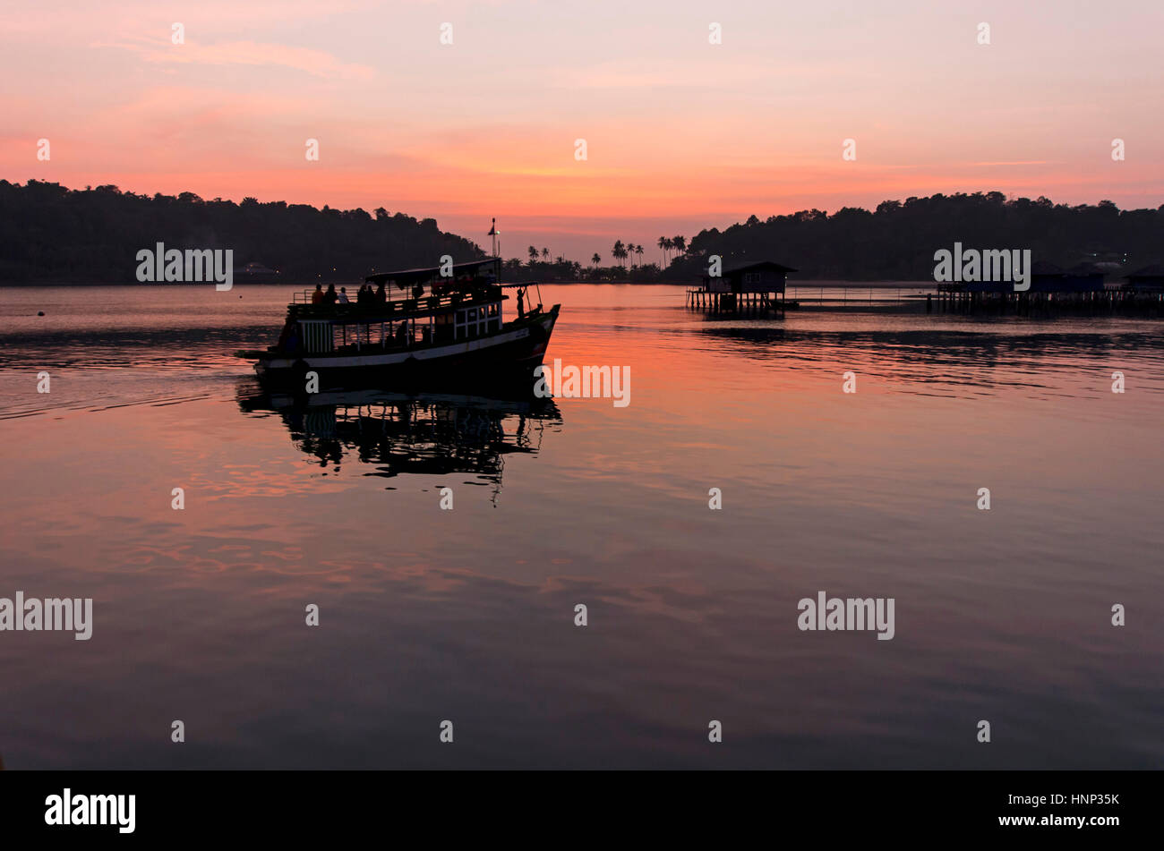 Ferry floating on the water at the bay of Bang Bao on Koh Chang in Thailand. Stock Photo