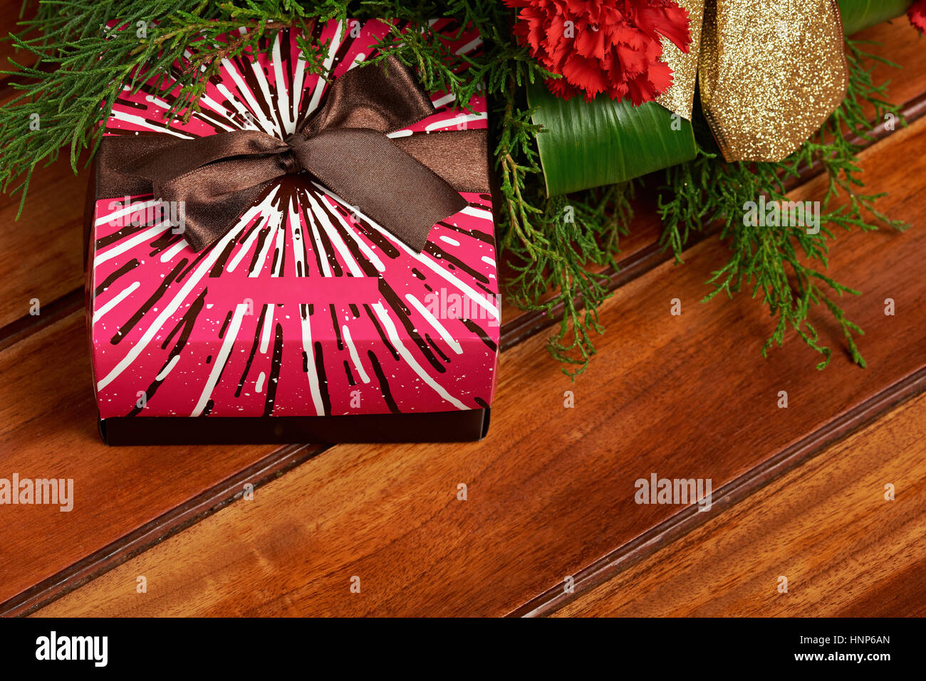 gift box under christmas tree dercoration on wooden background Stock Photo
