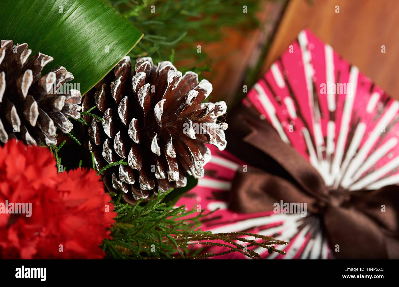 Pinecone on christmas decoration with blurred gift box background Stock Photo