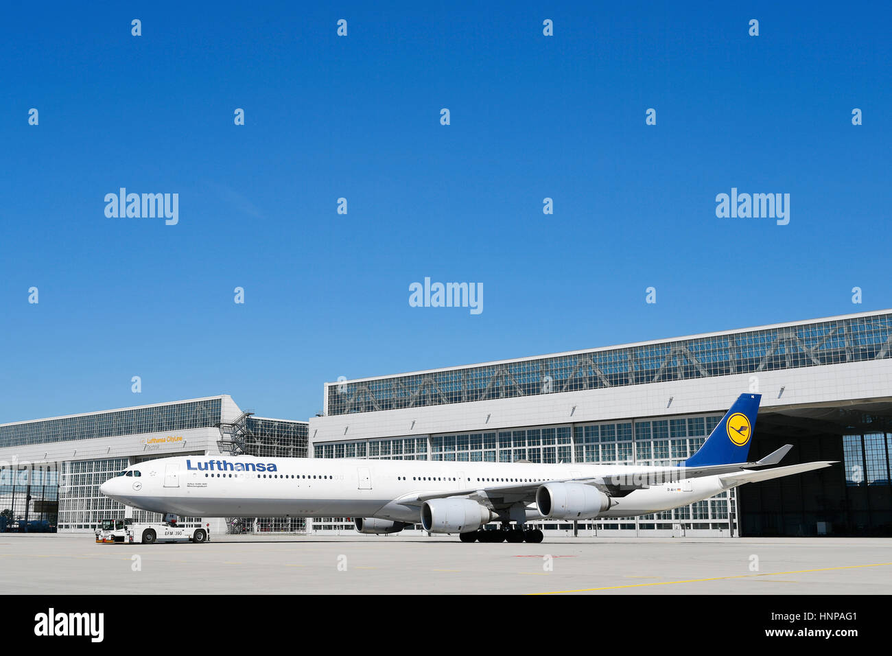 Lufthansa Airbus A340 with push-back truck in front of maintenance hangar, Hangar, Munich, Upper Bavaria, Germany Stock Photo