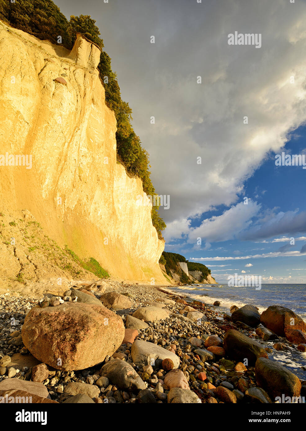 Chalk cliffs in the morning light, boulders on the beach, Jasmund ...