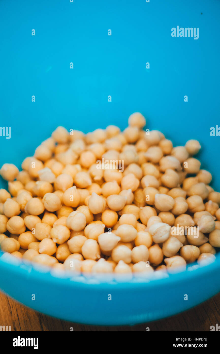 boiled chickpeas in a blue bowl Stock Photo