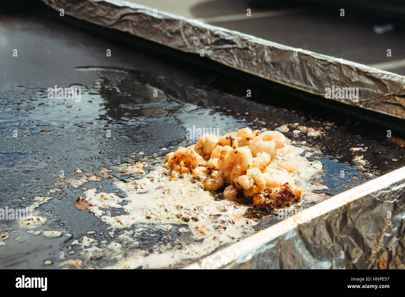 Prawns being cooked in a street food stall Stock Photo