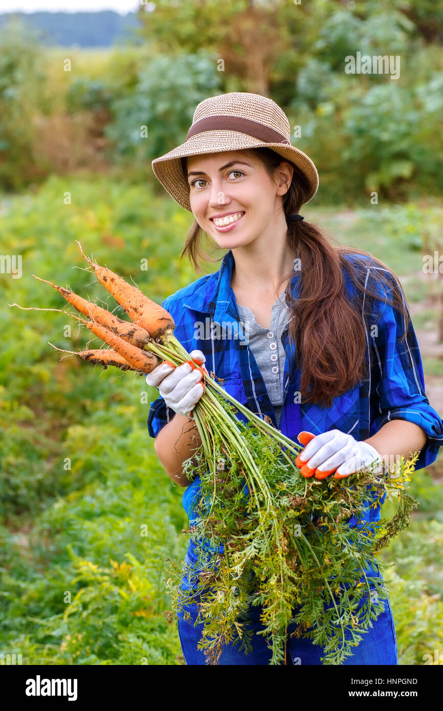 Gardening Woman With Organic Carrots In A Vegetable Garden Happy Girl