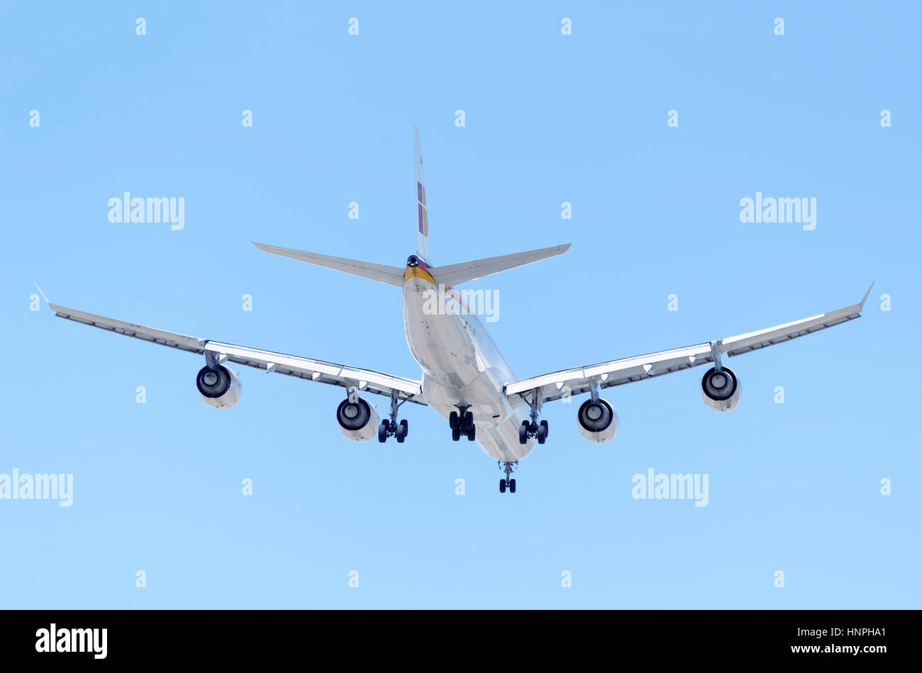 Plane Airbus A340, of Iberia airline, is landing. Back view. Spanish