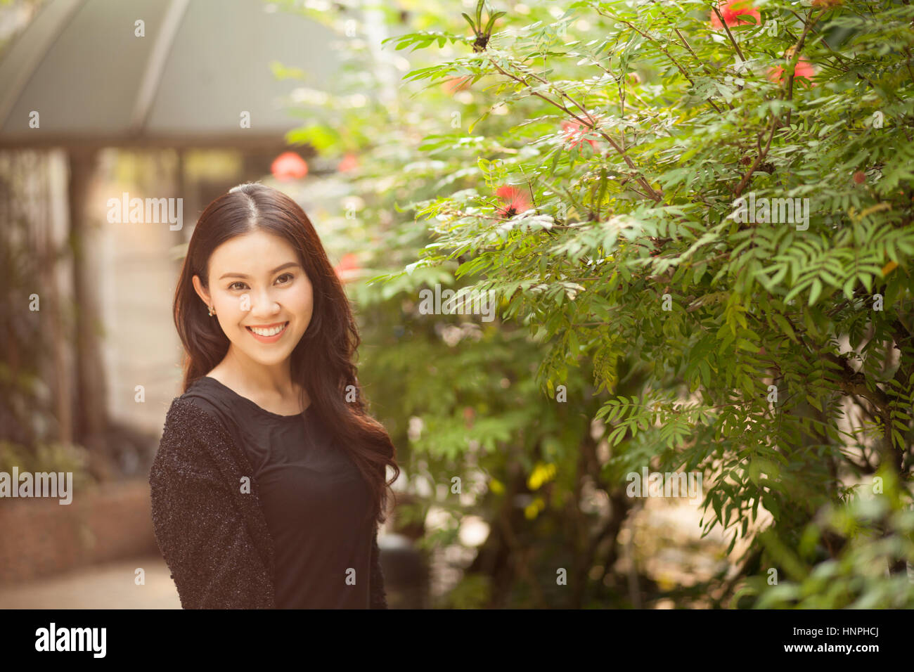 Pretty Thai girl Smiling at the park Stock Photo