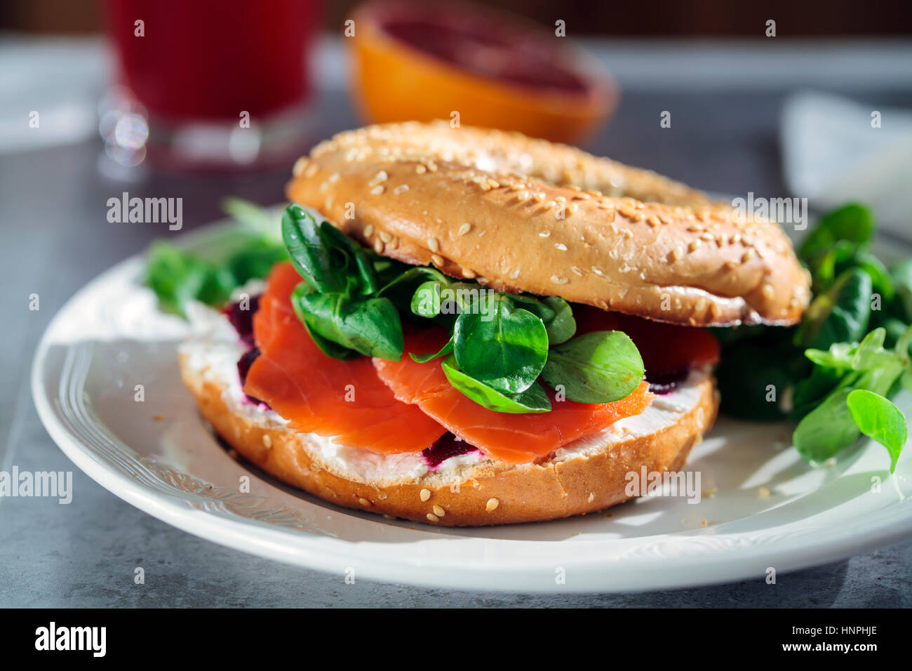 Bagel with cream cheese, smoked salmon and beetroot Stock Photo