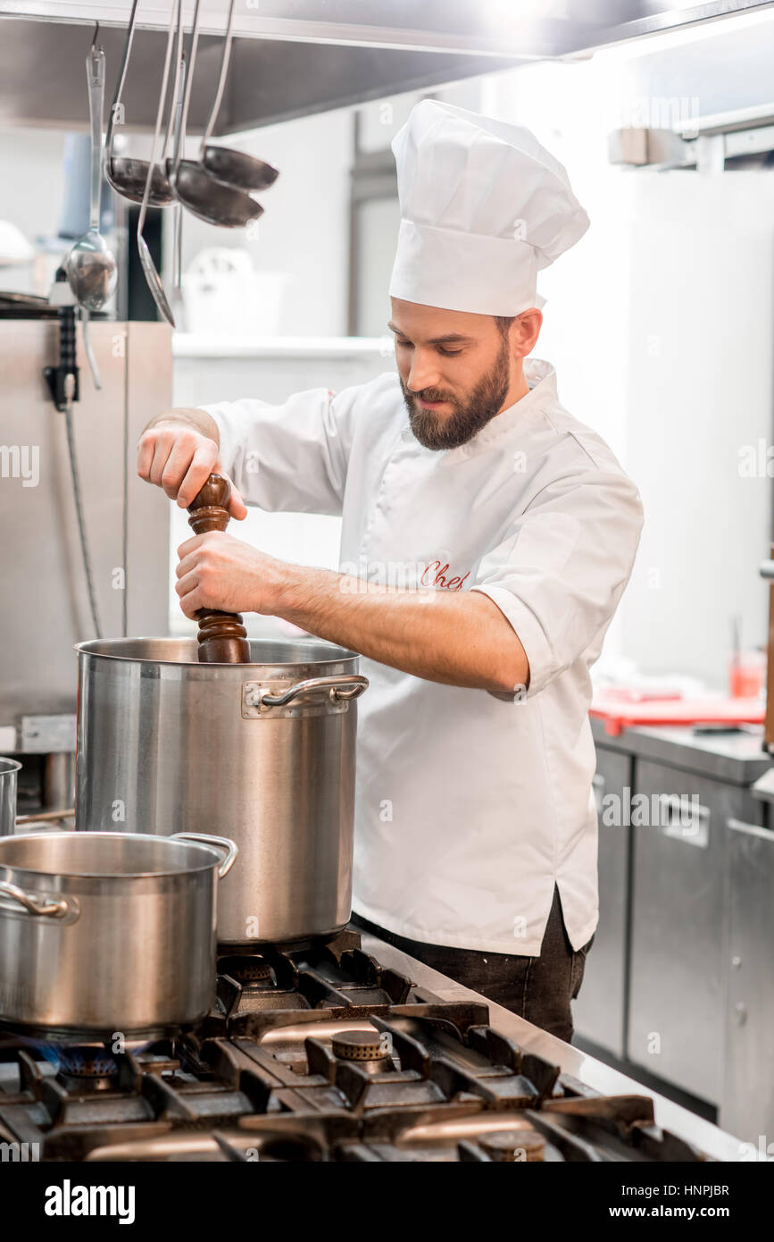 Cook with big cooking pot in the kitchen Stock Photo - Alamy