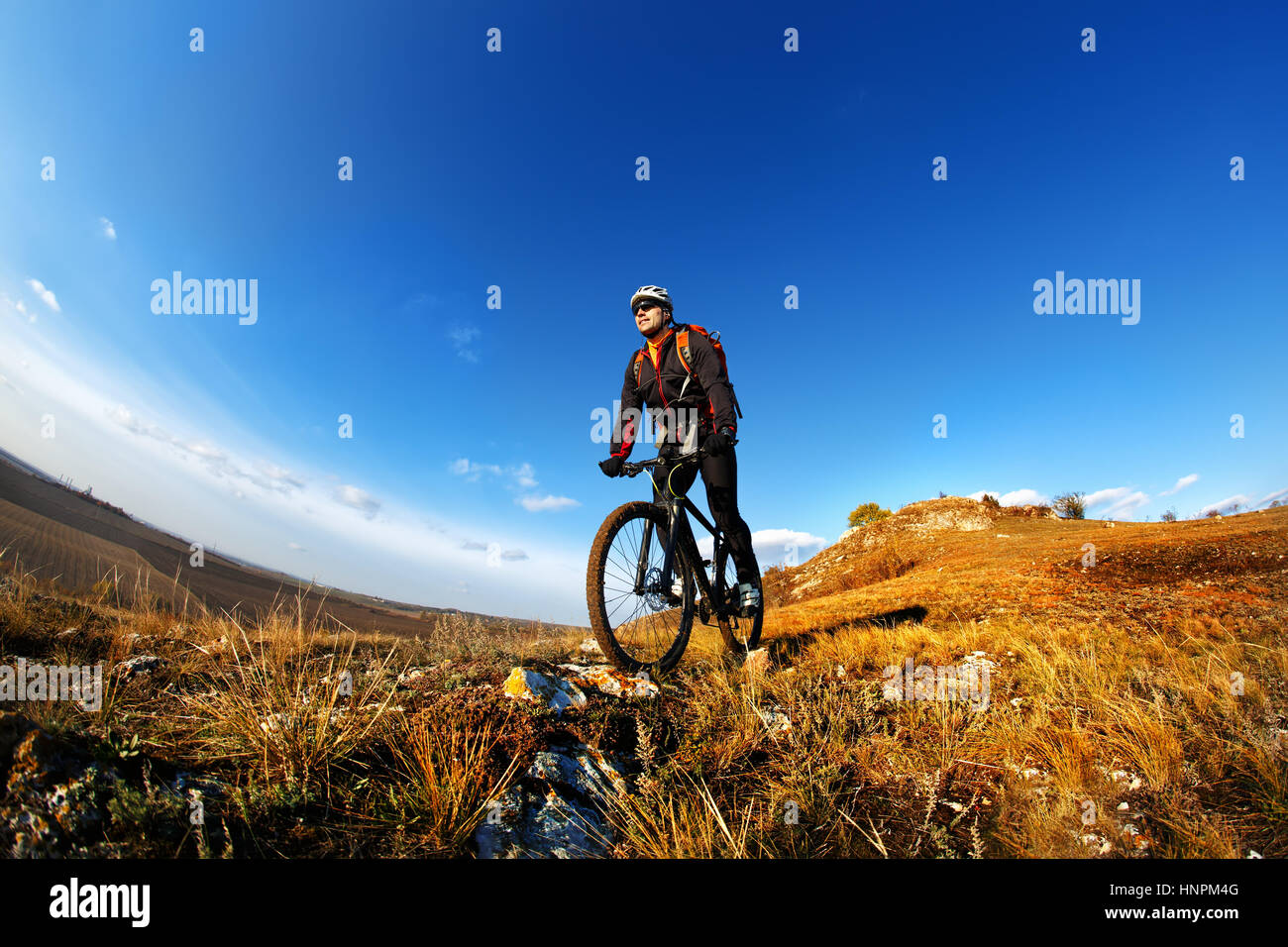 Single Track Riding Mountain Bike cyclist riding single track outdoor with blue sky on ...