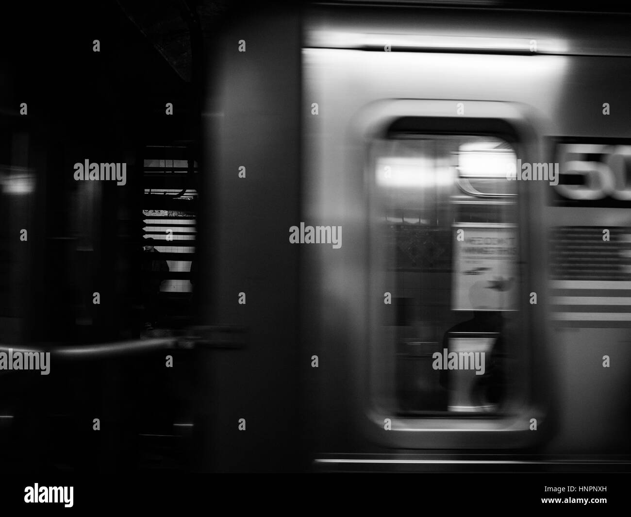New York Subway System. A subway train rushes past. Stock Photo