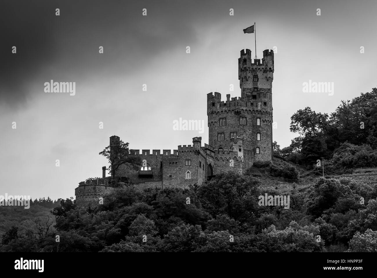 Sooneck Castle at the outermost tip of the Soon Forest above Niederheimbach in cloudy weather on the Rhine River in Germany. Black and white photograp Stock Photo