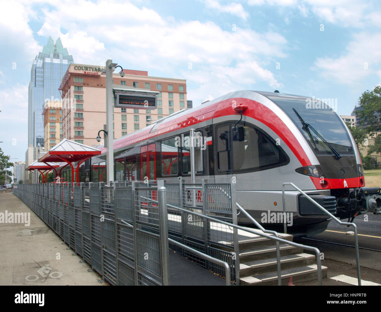 Capital MetroRail station in downtown Austin, Texas. Frost Bank Tower skyscraper is in